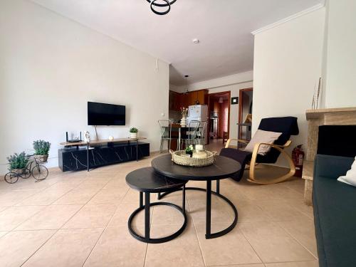 a living room with a table and a couch at Casa d'Angelo by Horizon Homes in Orfánion