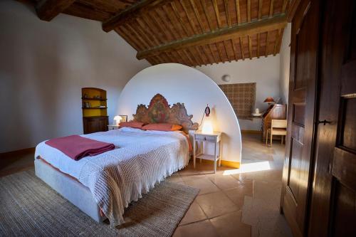 a bedroom with a large bed in an arched room at Agriturismo Petra in Suvereto