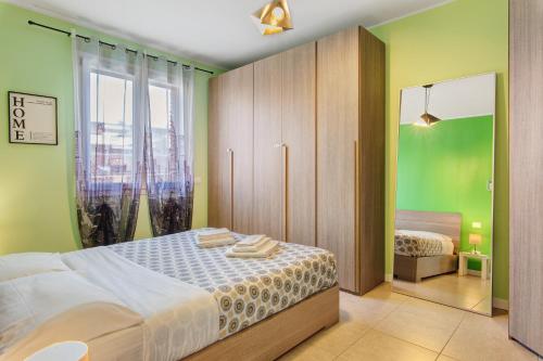 a bedroom with a bed and a large window at Maison Emozioni Terrace in Limbiate