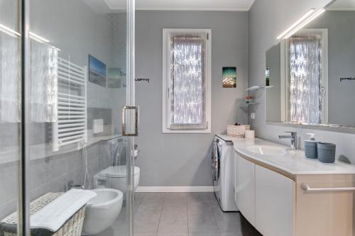a bathroom with a toilet and a sink and a shower at Maison Emozioni Terrace in Limbiate