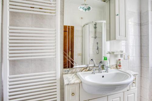 a white bathroom with a sink and a mirror at Col Di Metino - Umbria in Gualdo Tadino