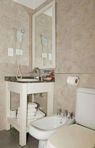 a bathroom with a sink and a toilet at Cabañas Antares in Mar de las Pampas