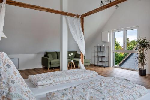 a bedroom with a bed and a living room at Ferienhaus Ebringen in Ebringen