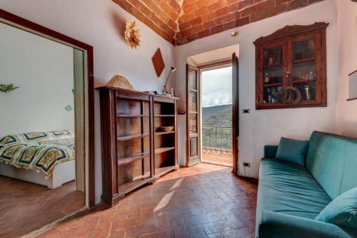 a living room with a couch and a window at Nadine - Bilocale In Centro in Marciana