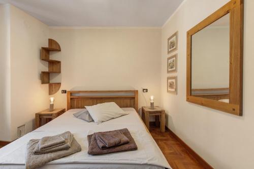 a bedroom with a bed with two towels on it at Maison Gnemaz Grand Combin in Aosta