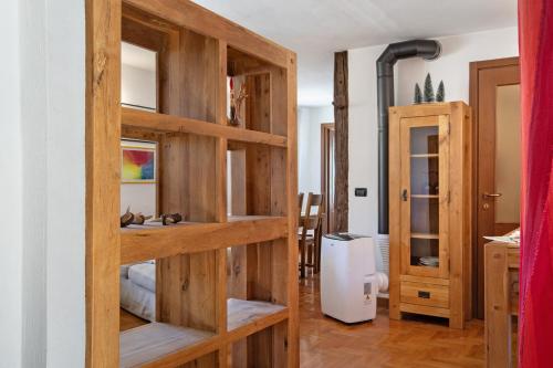 a room with wooden book shelves in a room at Maison Gnemaz Grand Combin in Aosta