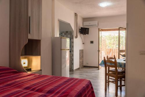 a bedroom with a bed and a dining room with a table at Monolocale Arredato - Le Terrazze in Ribera