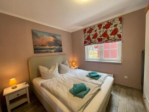 a bedroom with a bed with two pillows on it at Ferienhaus Eichelhäher in Zossen