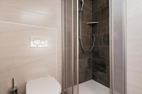 a bathroom with a shower with a toilet and a shower at Forchnerhof Apt Rose in Maranza
