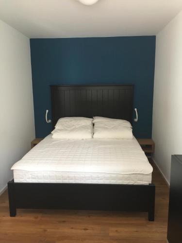 a bedroom with a bed with a blue wall at Ferienwohnung Strandgut in Glücksburg
