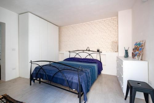 a bedroom with a bed and a brick wall at Leonardò, non solo mare in Nardò