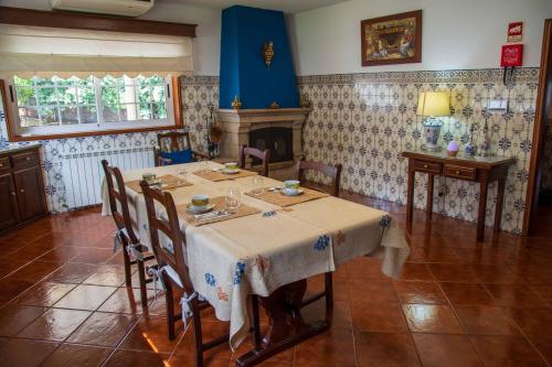 a dining room with a table and a fireplace at Recanto Transmontano in Macedo de Cavaleiros