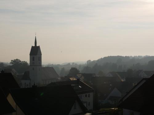 a view of a town with a church tower at Ferienwohnung Haus Maria in Wäschenbeuren