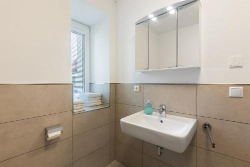 a bathroom with a sink and a mirror at Torhaus Schloss Wocklum in Balve