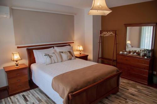 a bedroom with a large bed and a mirror at Recanto Transmontano in Macedo de Cavaleiros