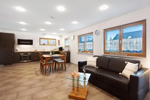 a living room with a black couch and a table at Haus Morgensonne in Weilheim