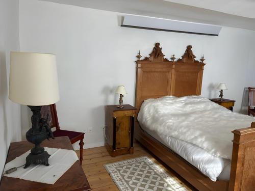 a bedroom with a bed and a table with a lamp at Burghaus in Bad Driburg