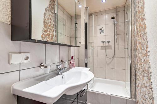 a bathroom with a sink and a shower at Haus Monterosa in Baden-Baden