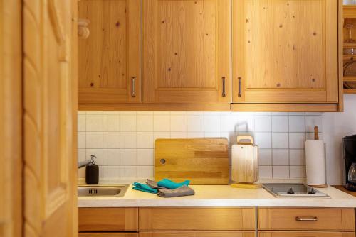 a kitchen counter with wooden cabinets and a sink at Almzeit in Farchant