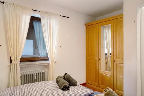 a bedroom with a bed and a window at Almzeit in Farchant