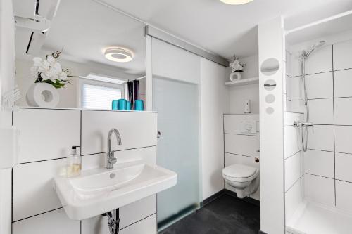 ein weißes Badezimmer mit Waschbecken und Toilette in der Unterkunft Happy-Nest in Oberkrämer