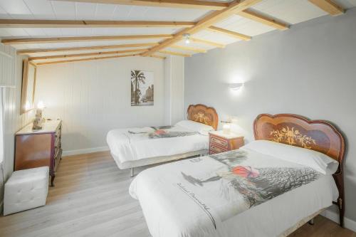 a bedroom with two beds and a television in it at El Cedro in Abejar