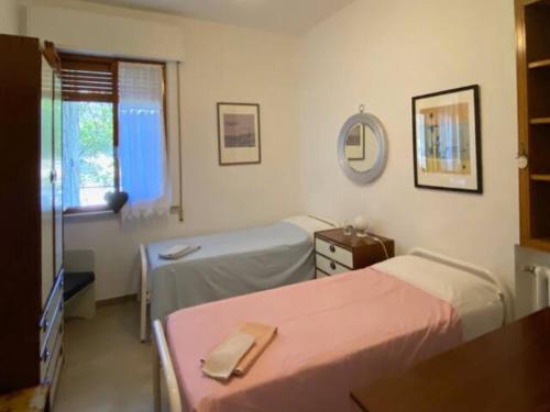 a hospital room with two beds and a mirror at Via Verdi 14 in Mondolfo