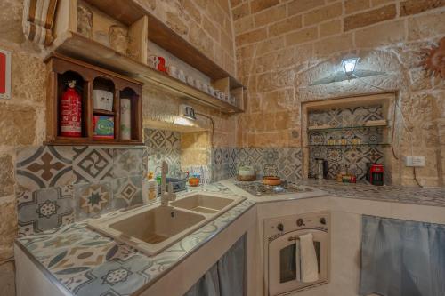 a kitchen with a sink and a counter top at San Leonardo Apartments in Lecce