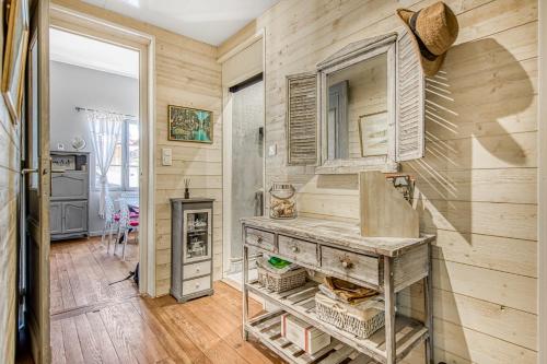 a room with a wooden wall and a wooden table at Maison de pecheur Arcachon in Arcachon