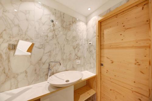 a bathroom with a white sink and a shower at Roda A Parte in Vigo di Fassa