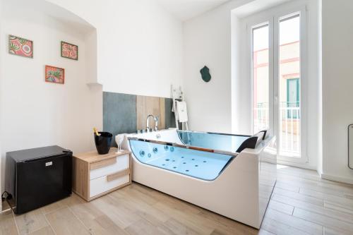 a bathroom with a tub in the middle of a room at Suite N12 - Luxury Apartment in Bari