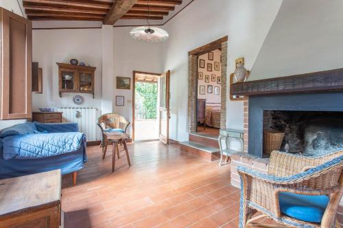 a living room with a fireplace and a bed at La Casa dei Mandorli in Talamone