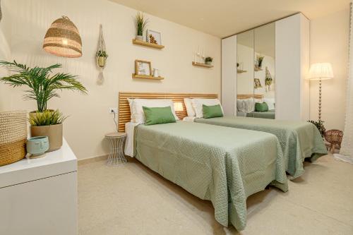 a bedroom with two beds and a mirror at Dependance con piscina in Punta Molara