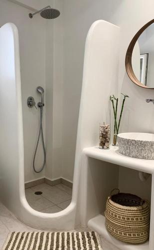 a white bathroom with a shower and a sink at Sofias House Fresh And Comfy in Naxos Chora