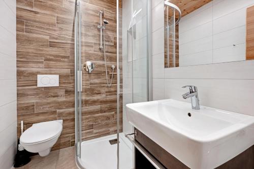 a bathroom with a sink and a toilet and a shower at Heiserhof App Holunder in Racines