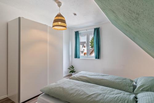 a bedroom with a bed and a window at Haus 23 in Ettenheim