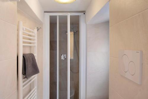 a shower with a glass door in a bathroom at Casa Edda - Sea view in Diano Marina