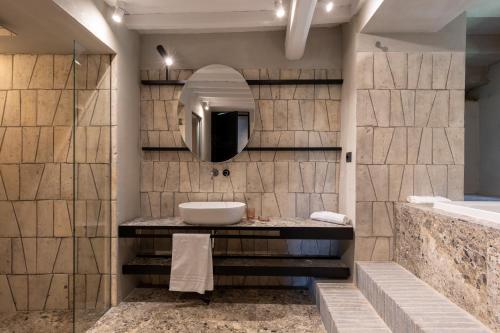 a bathroom with a sink and a mirror at Suite Cantina in San Gimignano