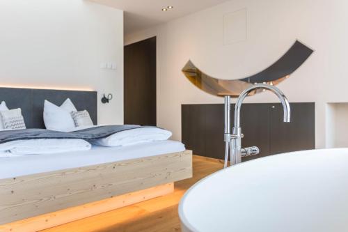 a bedroom with a bed and a bath tub at Aura Chalets - Nr 2 in Castelrotto