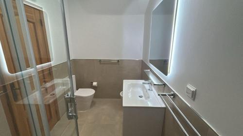a small bathroom with a sink and a toilet at Casa Primavera in Carvoeiro