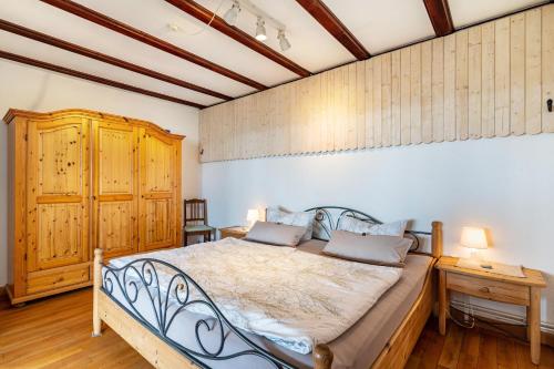a bedroom with a bed and a wooden cabinet at Augensteins Burgzimmer in Seelbach