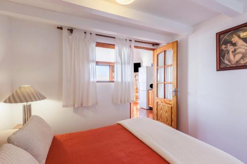 a bedroom with a bed and a window at Casa Victor - Apartment 2 in La Orotava