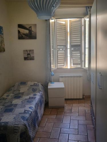 a bedroom with a bed and a window at Elena's Guest House in Urbino