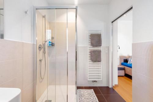 a bathroom with a shower with a glass door at Ferienwohnung 3 Weger in Andrian