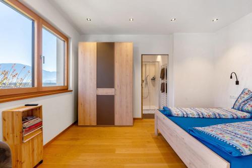 a bedroom with a bed and a window at Ferienwohnung 3 Weger in Andrian