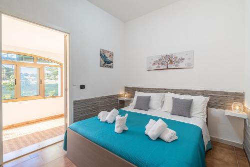 a bedroom with a large bed with two pillows at Villa Leale Plemmirio con piscina in Syracuse