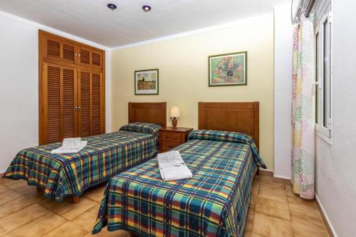 a hotel room with two beds in a room at Daniela in Pollença