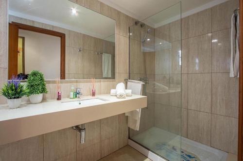 a bathroom with a sink and a glass shower at Daniela in Pollença