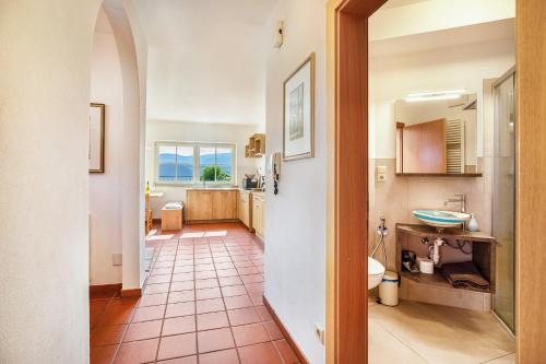 a bathroom with a sink and a toilet in a room at Weingut Lieselehof Apt Aurora in Caldaro