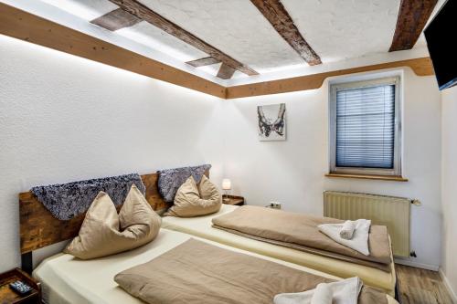 a bedroom with two beds and a window at im Fachwerk in Alsfeld